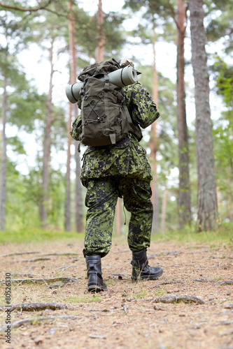 young soldier with backpack in forest © Syda Productions