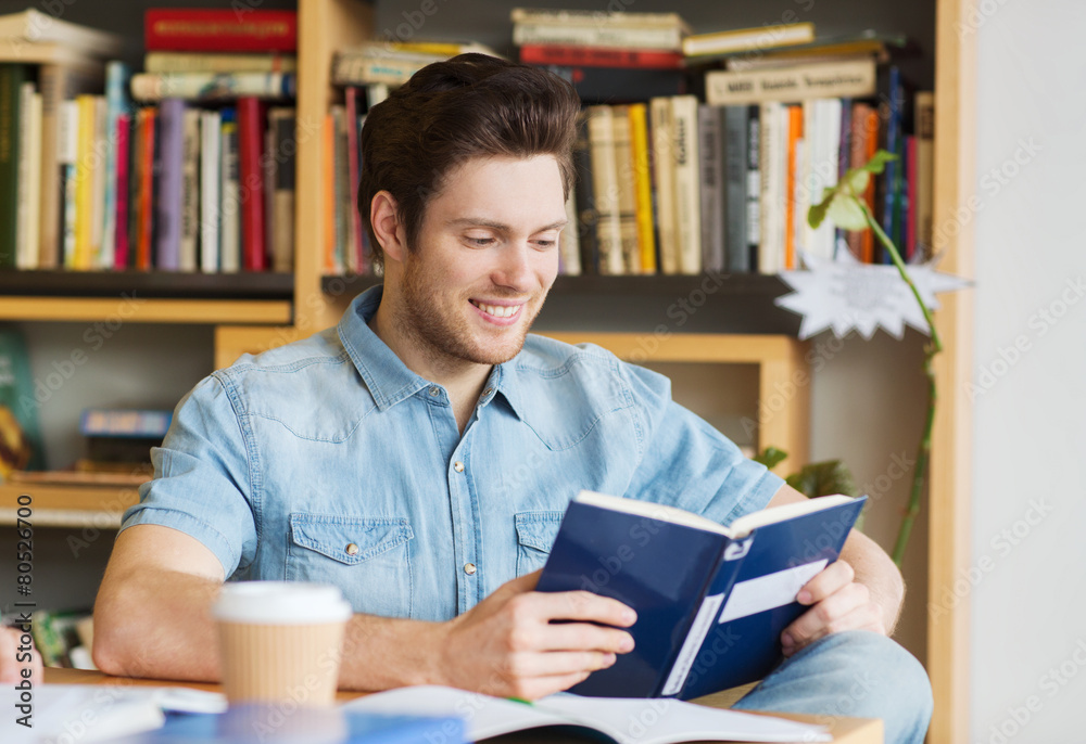 happy student reading book and drinking coffee happy student reading book and drinking coffee