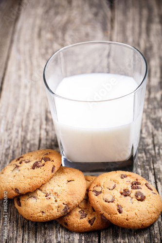 Cookies with milk on a wooden table.
