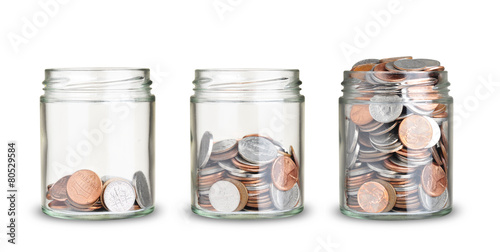 jars with different level of coins isolated on white