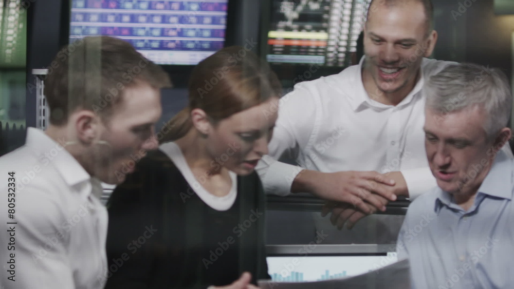 Casual team of financial traders taking a look at the figures Casual team of financial traders taking a look at the figures