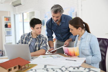 Teacher with students in architecture school