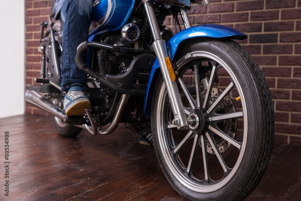 Wheel of a Sports Motorbike on the Wooden Floor