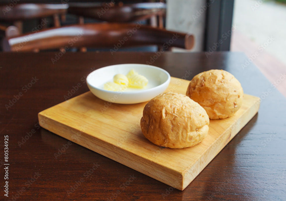 Bread with butter on a rustic cutting board Bread with butter on a rustic cutting board