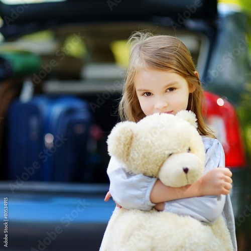 Adorable little girl with big teddy bear