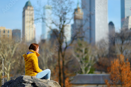Young woman looking at skyscrapers in Central Park