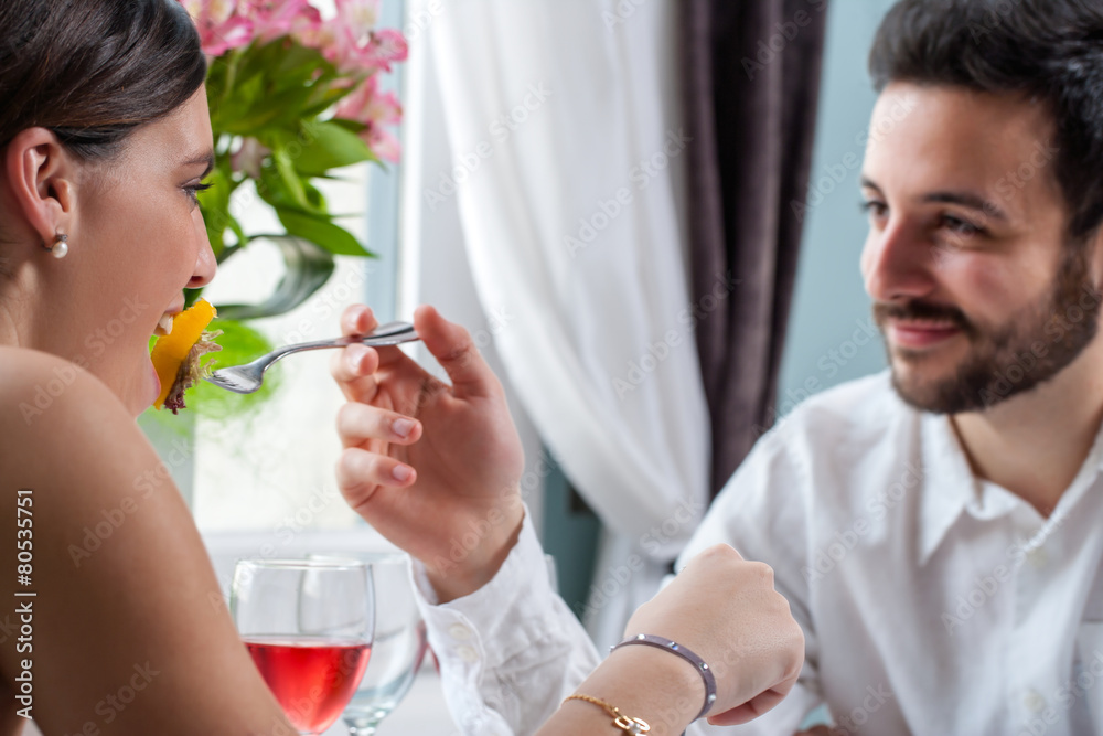 Boyfriend feeding girl at dinner. Boyfriend feeding girl at dinner.
