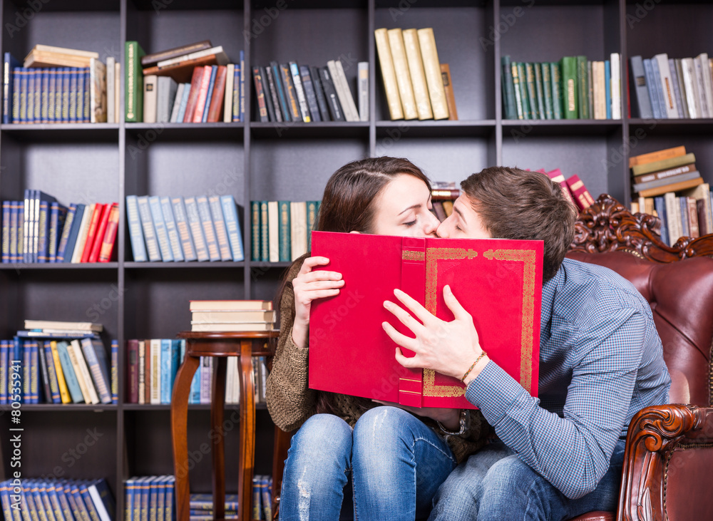 Romantic young couple sneaking a kiss