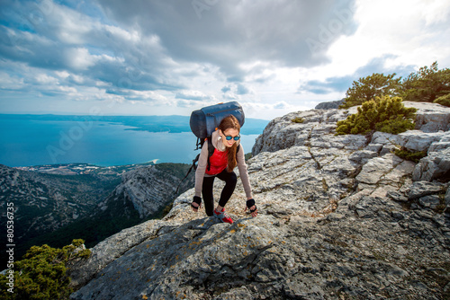 Young mountain climber on the top of island