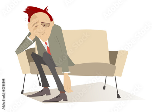 Man in low spirits sits on the sofa and puts hands down