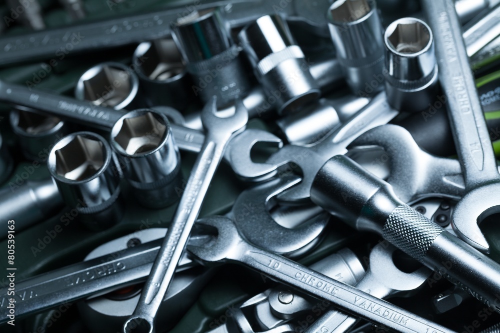 Tool. Heap of tools wrenches, nuts and bolts toned in metallic Stock