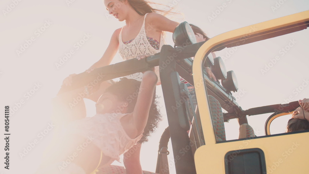 Happy Afro girl and friend getting out of car