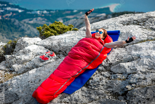 Woman in sleeping bag on the mountain