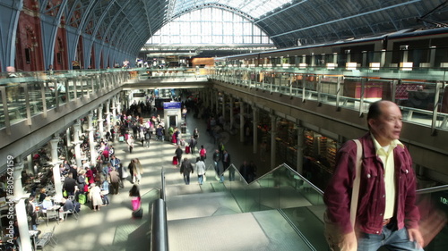 Time lapse of travelers and commuters passing through a London railway station
