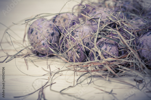 Easter eggs in a nest from a dry grass