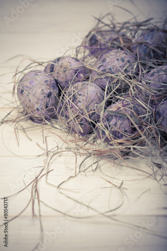 Easter eggs in a nest from a dry grass