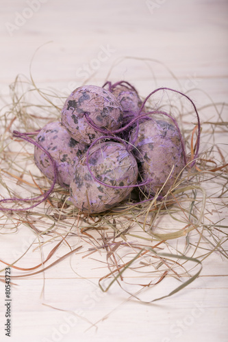 Easter eggs in a nest from a dry grass