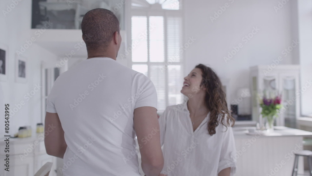 Young happy mixed race couple viewing a beautiful home to buy or rent Young happy mixed race couple viewing a beautiful home to buy or rent