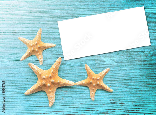 Starfish with blank on the wooden blue background.
