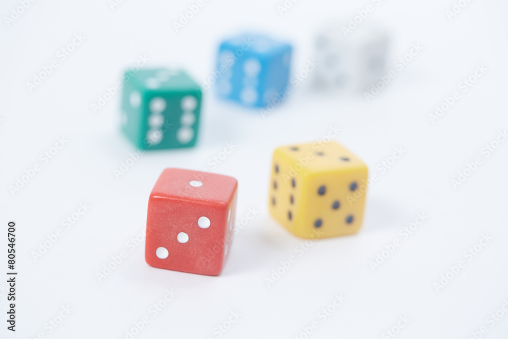 colored playing dice in a chaotic manner on a white background colored playing dice in a chaotic manner on a white background
