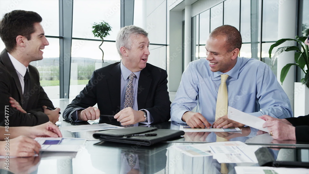Diverse team of business people are having a meeting in a light, modern building Diverse team of business people are having a meeting in a light, modern building