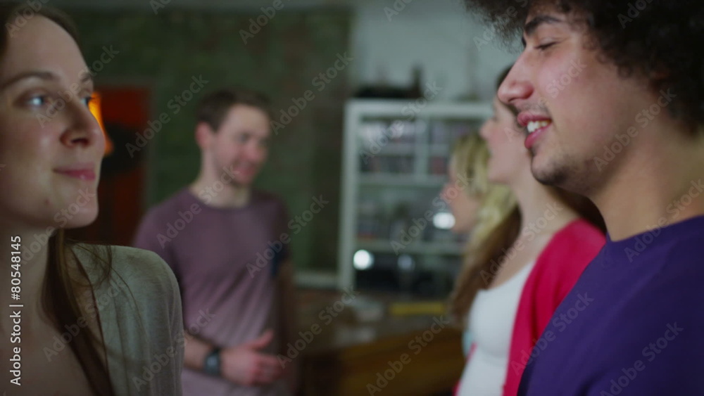 Carefree group of young friends, dancing and flirting together at a house party Carefree group of young friends, dancing and flirting together at a house party