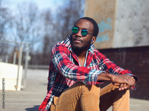 Outdoor fashion portrait of stylish young african man