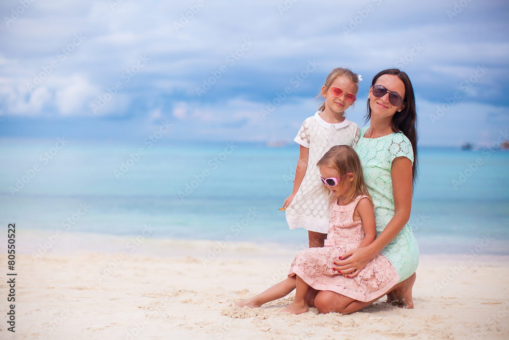 Happy mother and two her kids at exotic beach on sunny day Happy mother and two her kids at exotic beach on sunny day