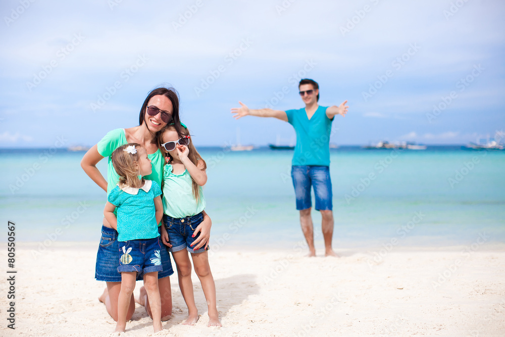 Happy family of four during summer vacation