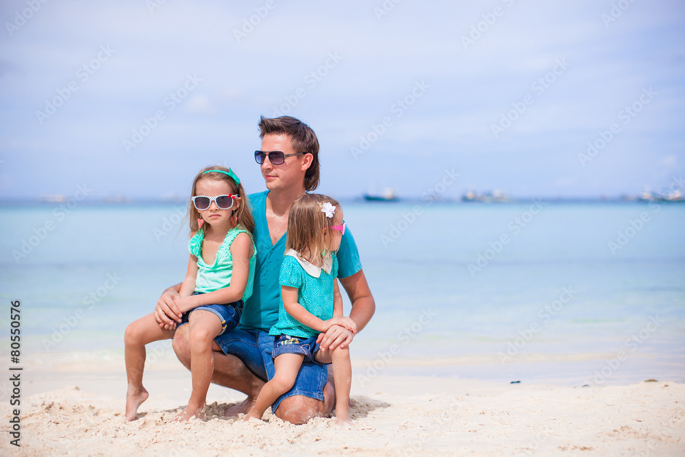 Young father and little girls have fun together during tropical