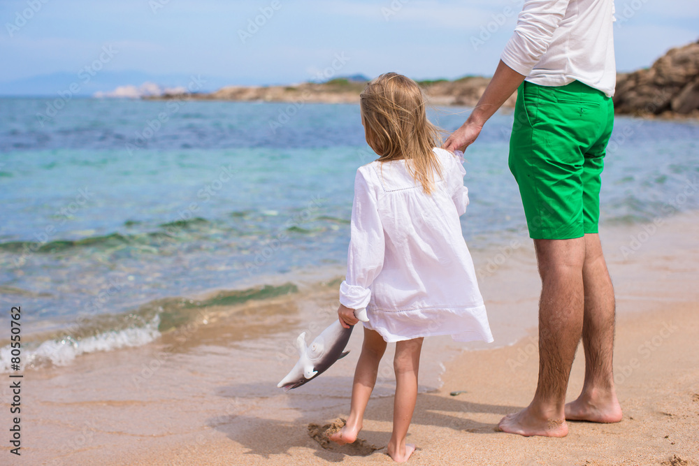 Happy father and little girl have fun during beach vacation