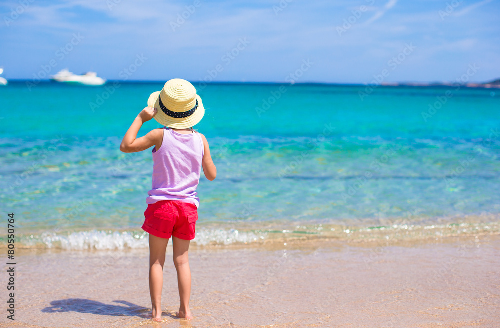 Adorable little girl have fun at tropical beach during vacation Adorable little girl have fun at tropical beach during vacation