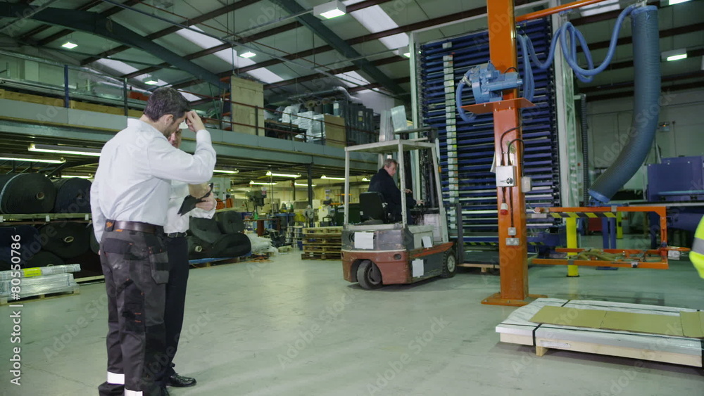 Team of busy warehouse workers lifting and moving empty wooden pallets Team of busy warehouse workers lifting and moving empty wooden pallets