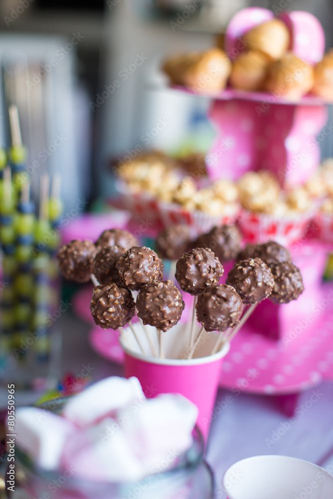Chocolate cakepops on holiday dessert table at kid birthday