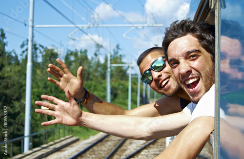Two young enjoy a train ride