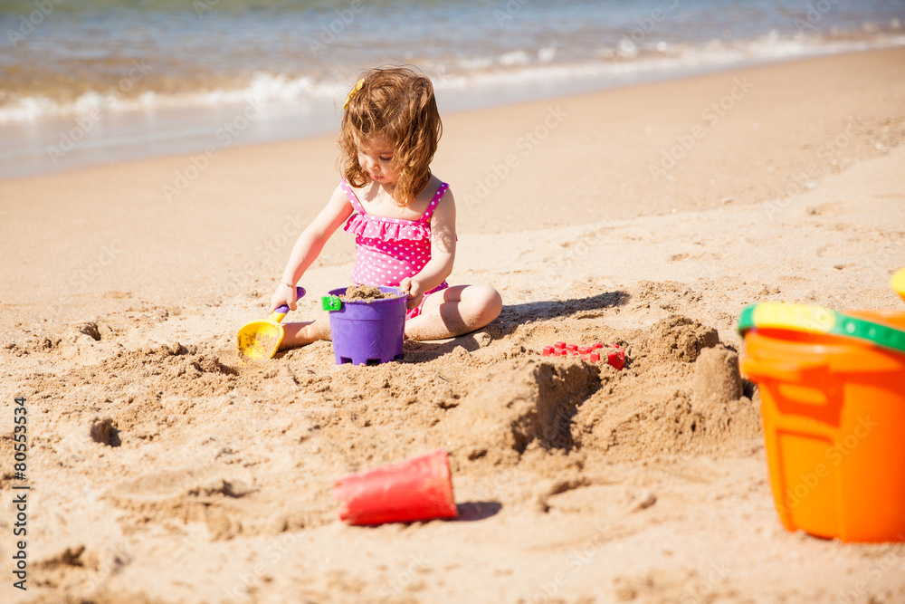 Little girl building sand castle Little girl building sand castle