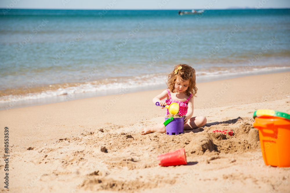 Little girl playing at the beach Little girl playing at the beach