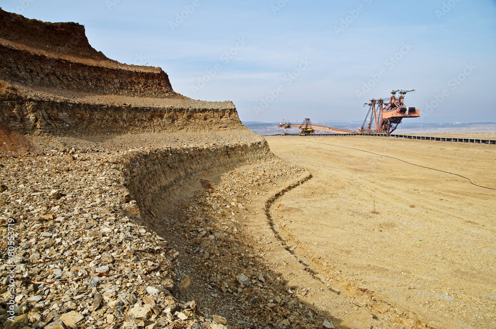 Bunk wall excavated pit mine. Mining giant excavator.