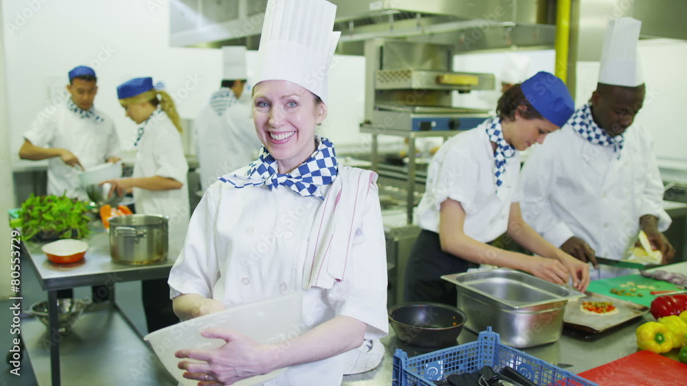 Portrait of a smiling chef in a commercial kitchen Portrait of a smiling chef in a commercial kitchen