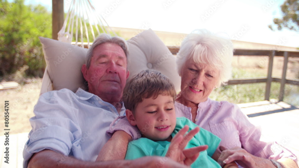 Grandparents and their grandson using a digital tablet Grandparents and their grandson using a digital tablet