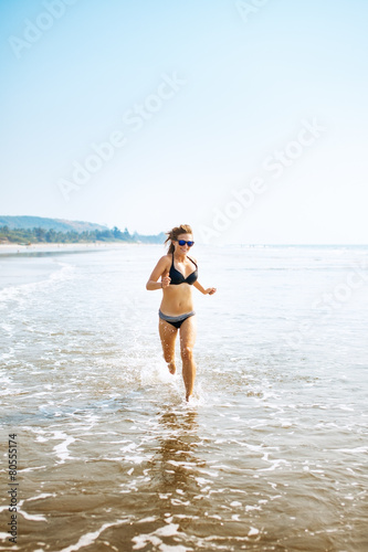 Woman on wide sandy beach