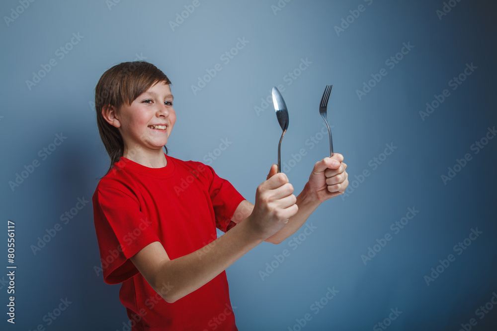 boy teenager European appearance in a red shirt holding a Dark B boy teenager European appearance in a red shirt holding a Dark B