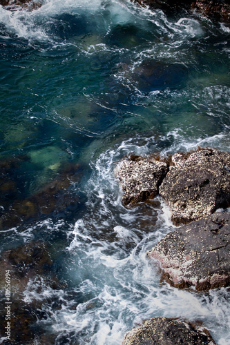 Ocean water splashing against rocks in the Galapagos Islands