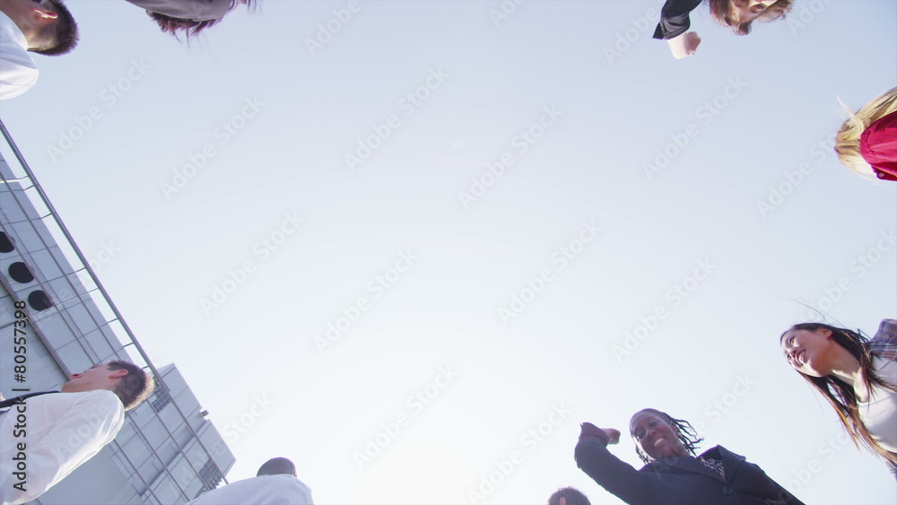 Business team stand in a circle with their hands together for a team talk