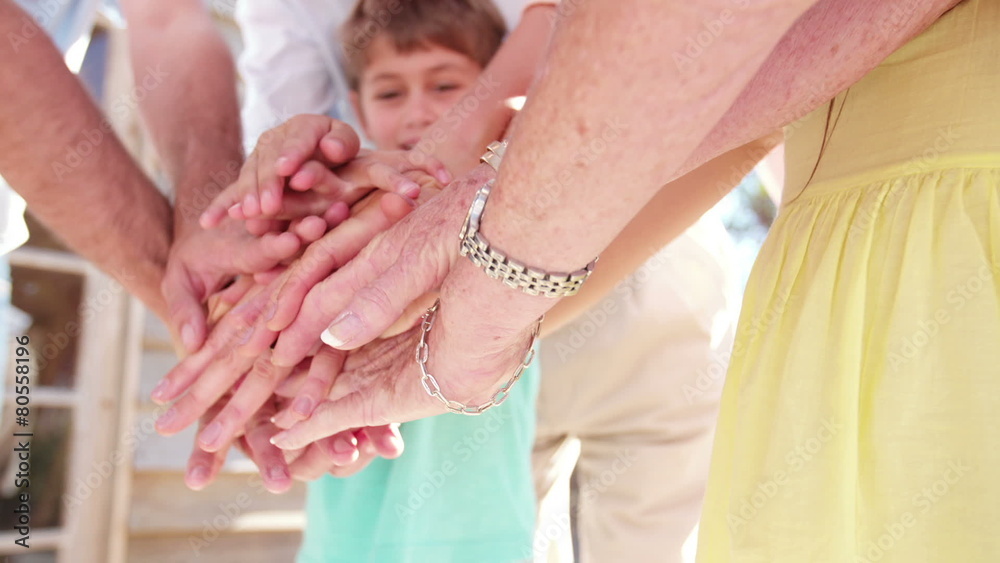 Family putting their hands together in a pile