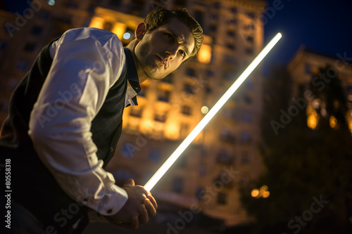 Handsome guy holding a lightsaber Jedi
