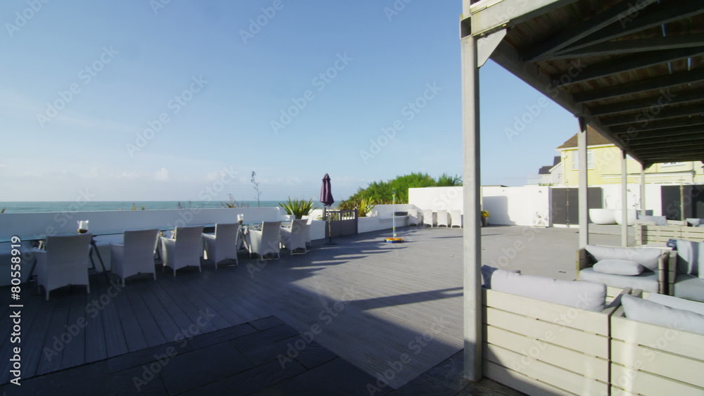 Exterior view of New England style beachside home and outdoor area. No people. Exterior view of New England style beachside home and outdoor area. No people.