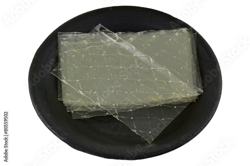 Sheets of Gelatin leaves on a dark ceramic plate