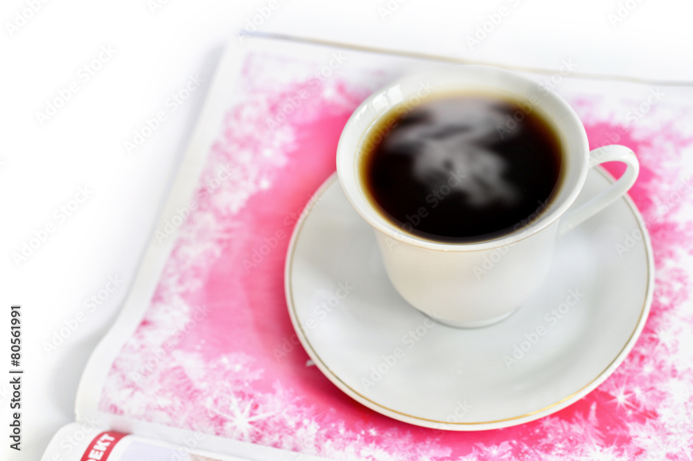 A cup of hot coffee and a magazine A cup of hot coffee and a magazine