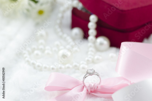 Diamond ring with pink ribbon and pearl necklace